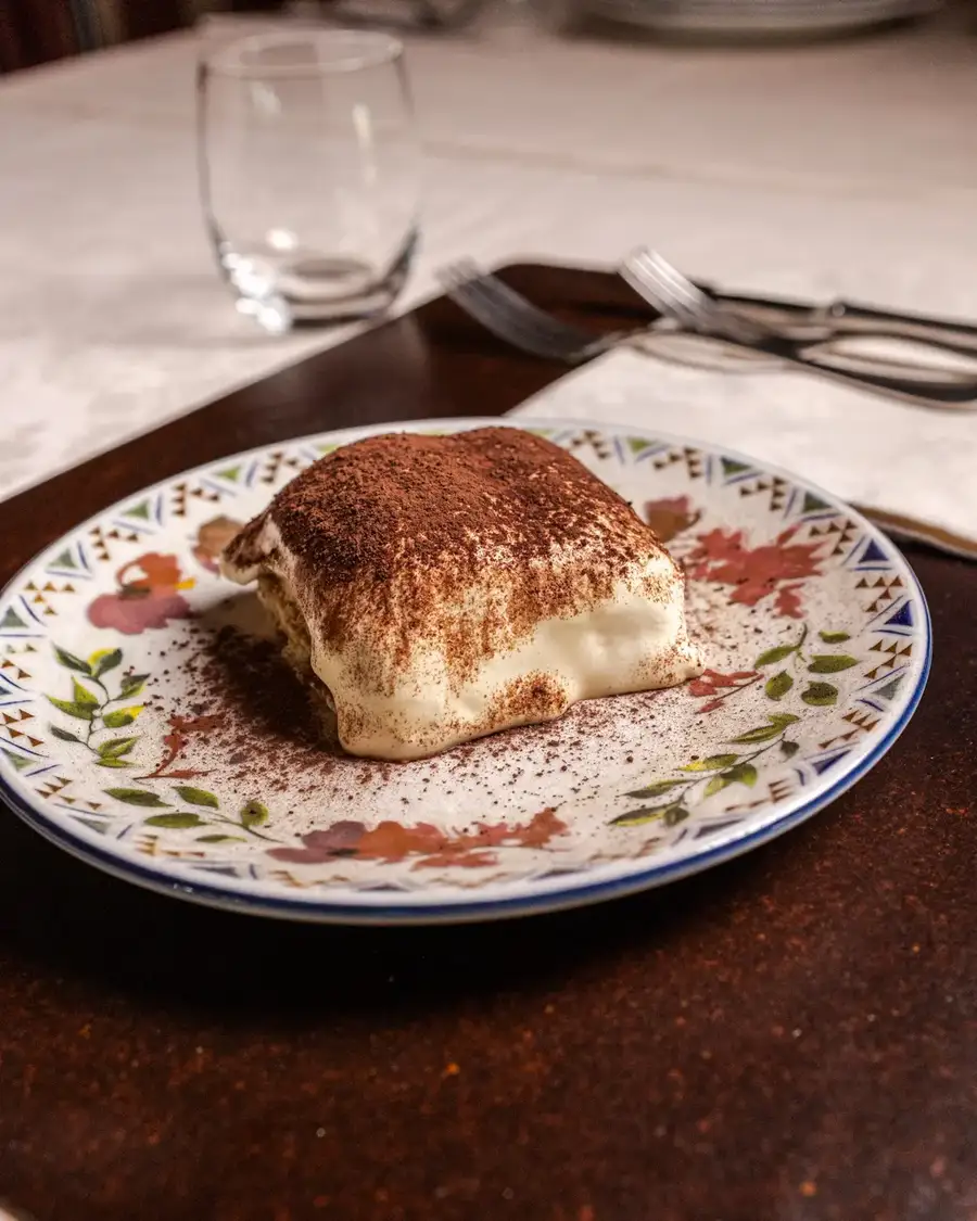 Tiramisù servito nel piatto decorato dell'Osteria alla Piazza